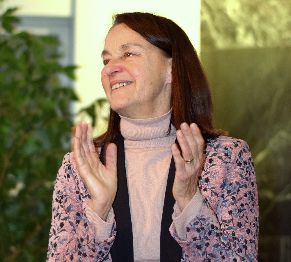 Libby Larsen smiling and clapping.