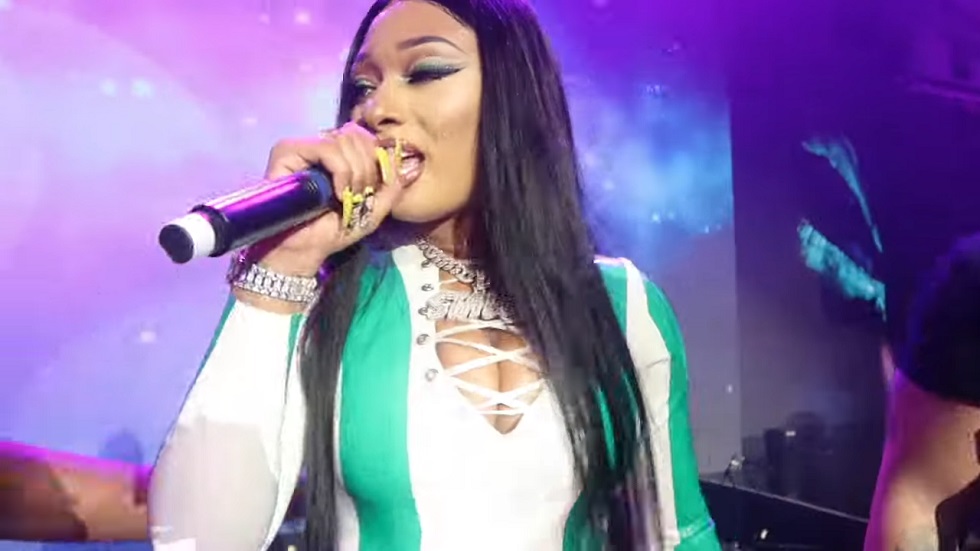 Megan Thee Stallion holding a microphone and performing in Lagos