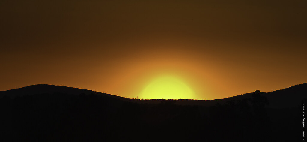 sunset over a hill or mountain